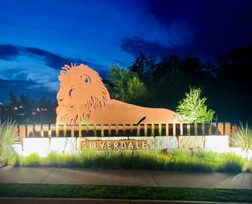 Solar flood lights illuminating an entrance sign