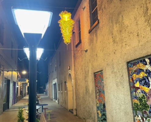 a solar coach light in a laneway