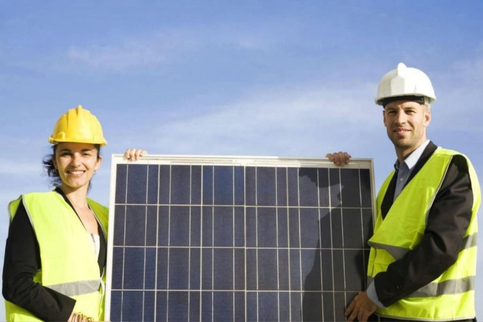 Commercial solar lighting company staff holding a solar panel